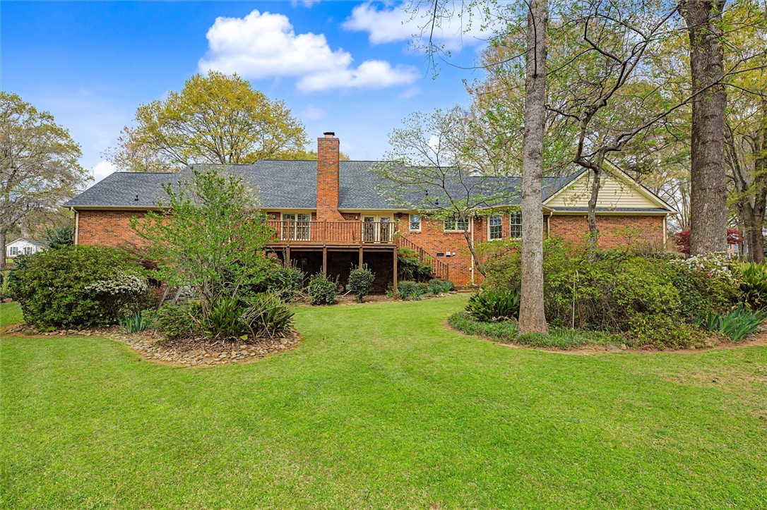 105 Hamilton Drive Anderson, SC 29621 - Photo 8 of 49 This spacious property offers a vibrant, well-maintained backyard with mature trees and ample green space.
