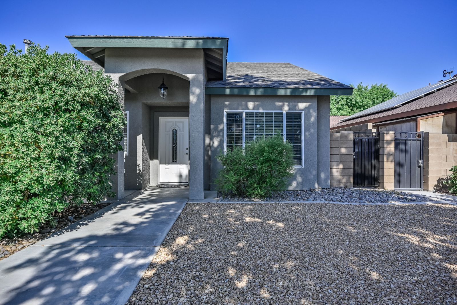 425 Acacia Street Ridgecrest, CA 93555 - Photo 2 of 49 a front view of a house with a garden