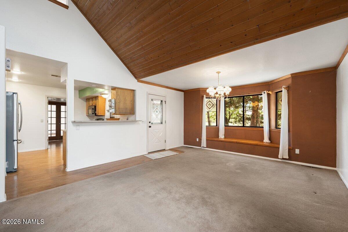 5535 East Western Star Road Flagstaff, AZ 86004 - Photo 4 of 49 a view of a livingroom with wooden floor and a kitchen