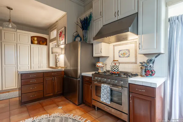 a kitchen with stainless steel appliances a stove a sink and a refrigerator