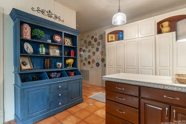 a kitchen with stainless steel appliances granite countertop a cabinets and a wooden floor