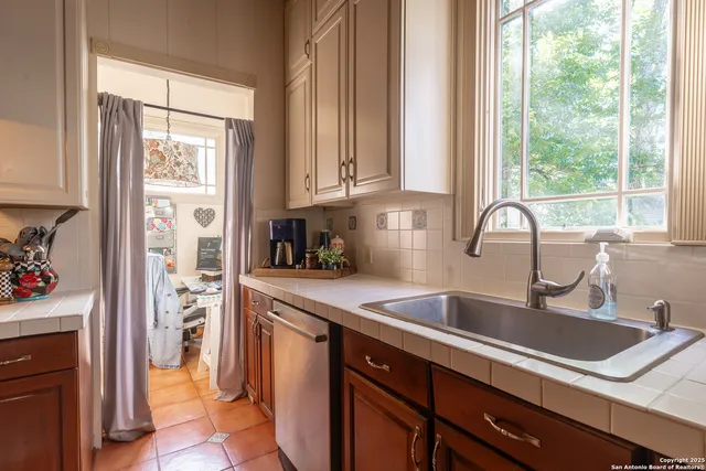 a kitchen with granite countertop a sink and a window