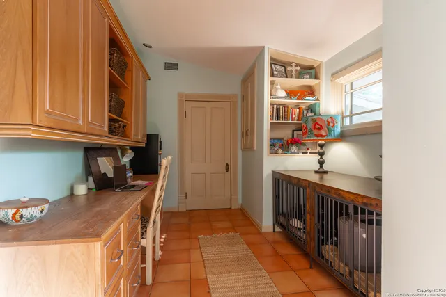 a view of a hallway to a livingroom with furniture