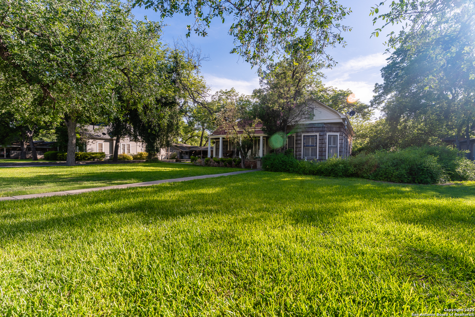 529 North High Street Uvalde, TX 78801 - Photo 29 of 37 a view of a house with a big yard and large trees