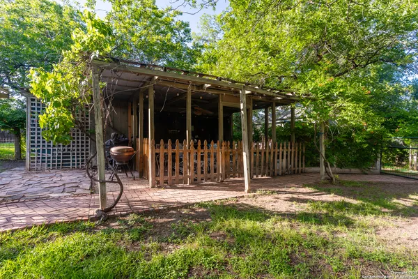 a view of a chair and table in backyard