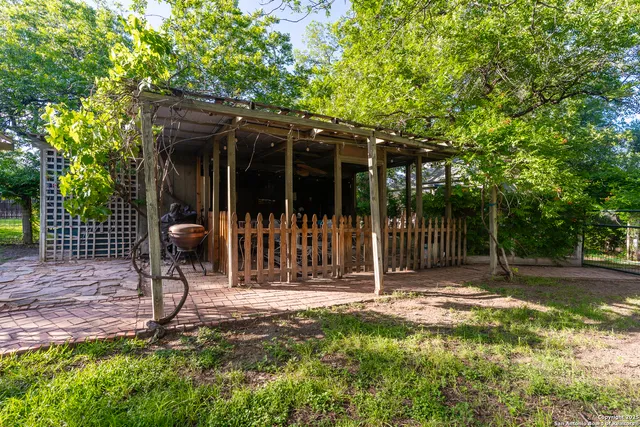 a view of a chair and table in backyard