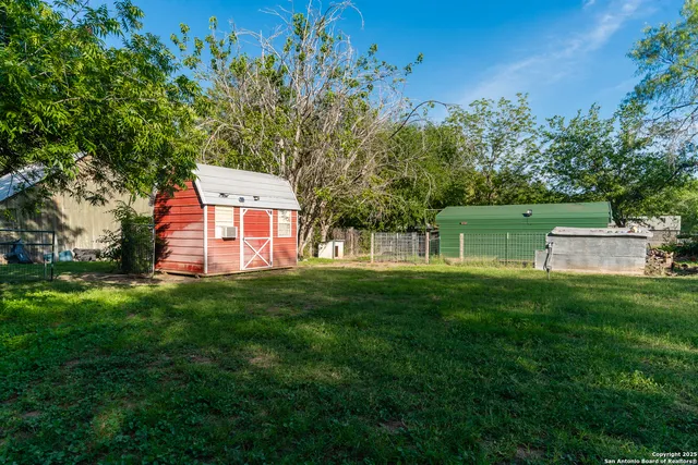 a view of a house with a backyard