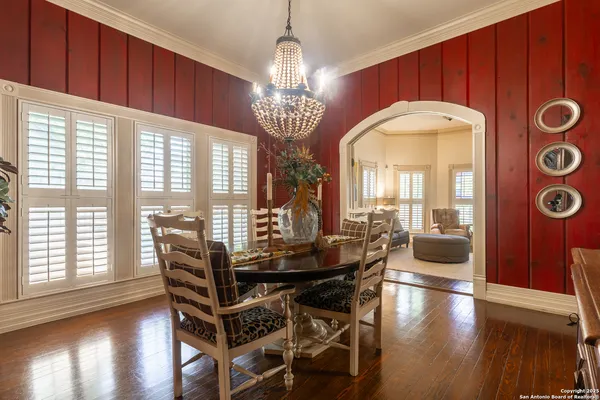 a view of a dining room with furniture and wooden floor