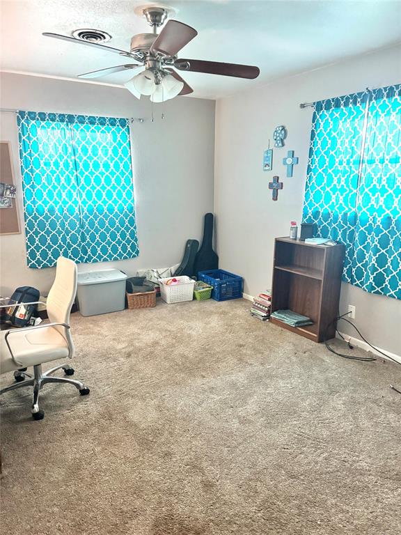 705 Loop Road Quanah, TX 79252 - Photo 12 of 14 a bedroom with furniture and a window