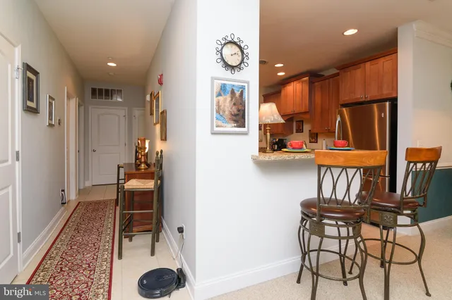 a hallway view with furniture a chandelier a rug and a window