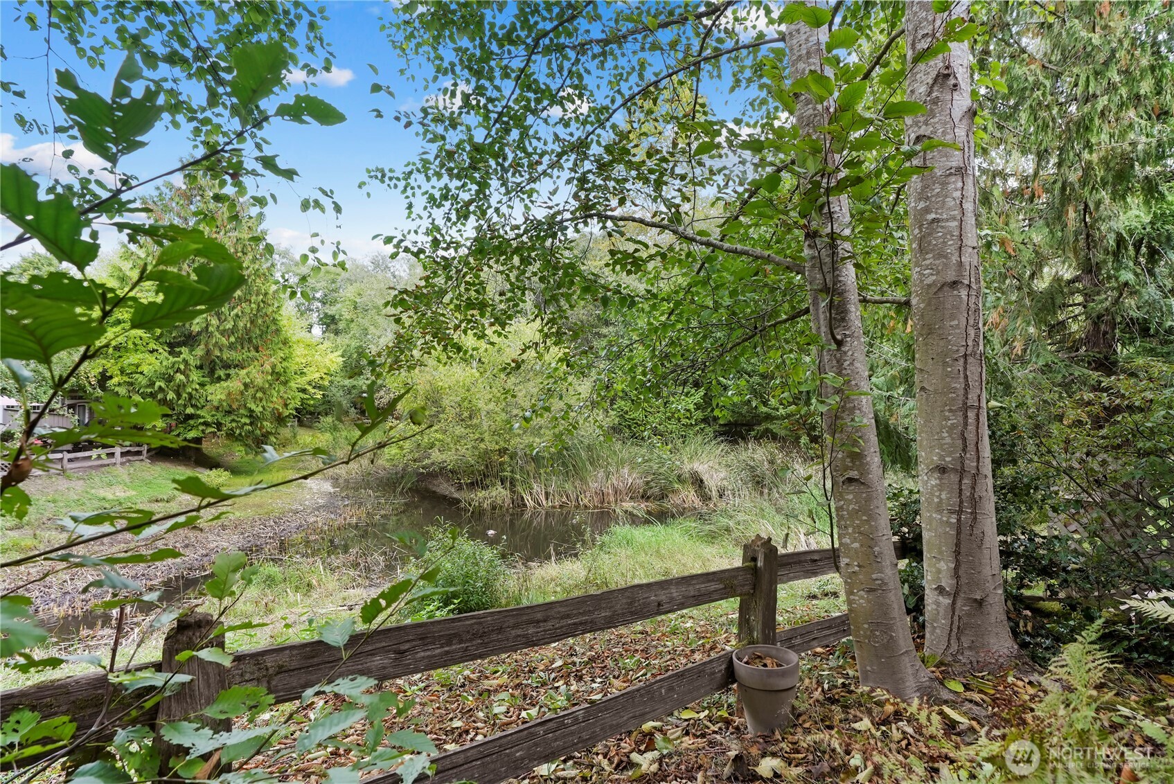 14714 53rd Avenue West, Unit 116 Edmonds, WA 98026 - Photo 1 of 30 a view of a garden with a bench