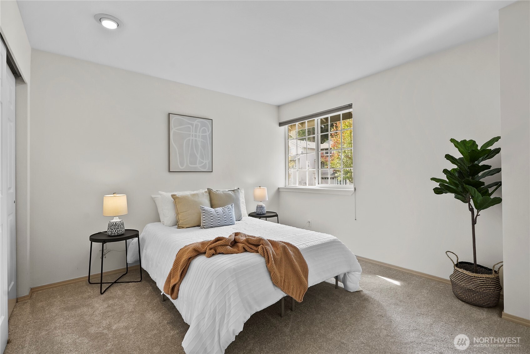 14714 53rd Avenue West, Unit 116 Edmonds, WA 98026 - Photo 20 of 30 a bedroom with a bed and a potted plant