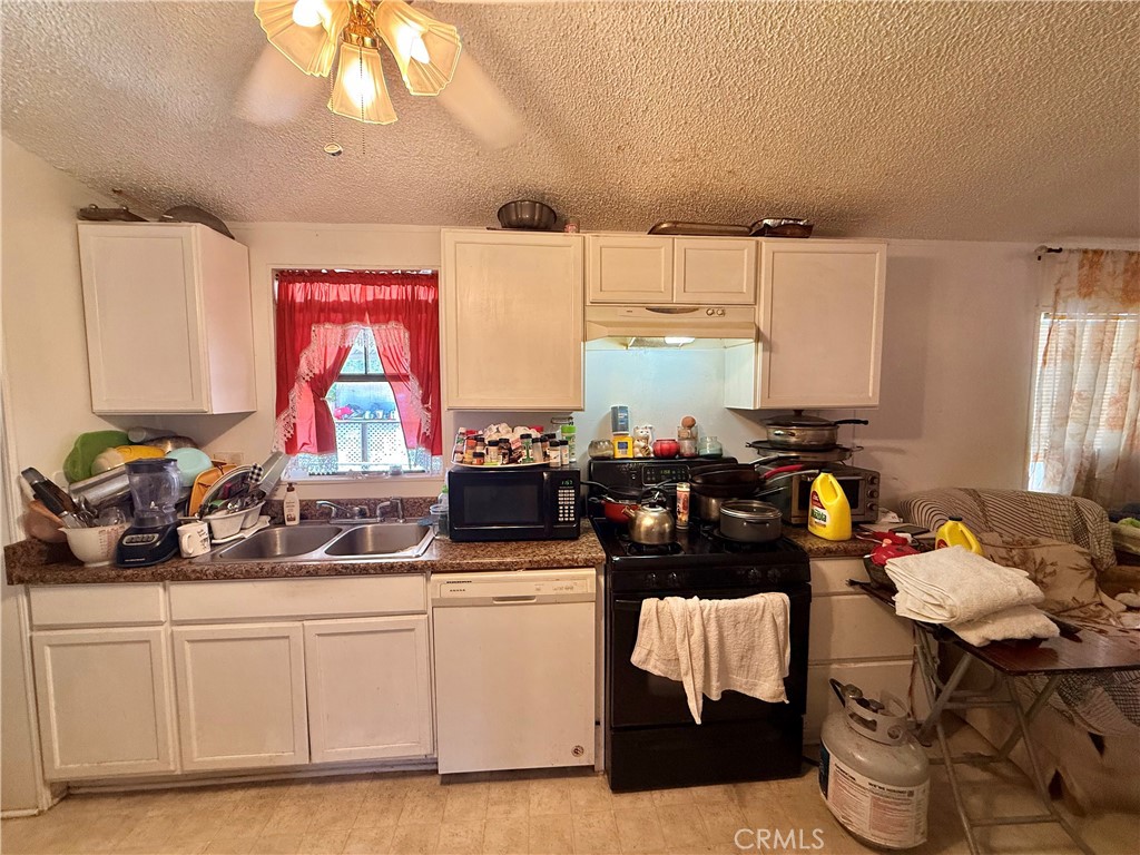 22020 Nisqually Road, Unit 65 Apple Valley, CA 92308 - Photo 14 of 14 a kitchen with a sink and cabinets