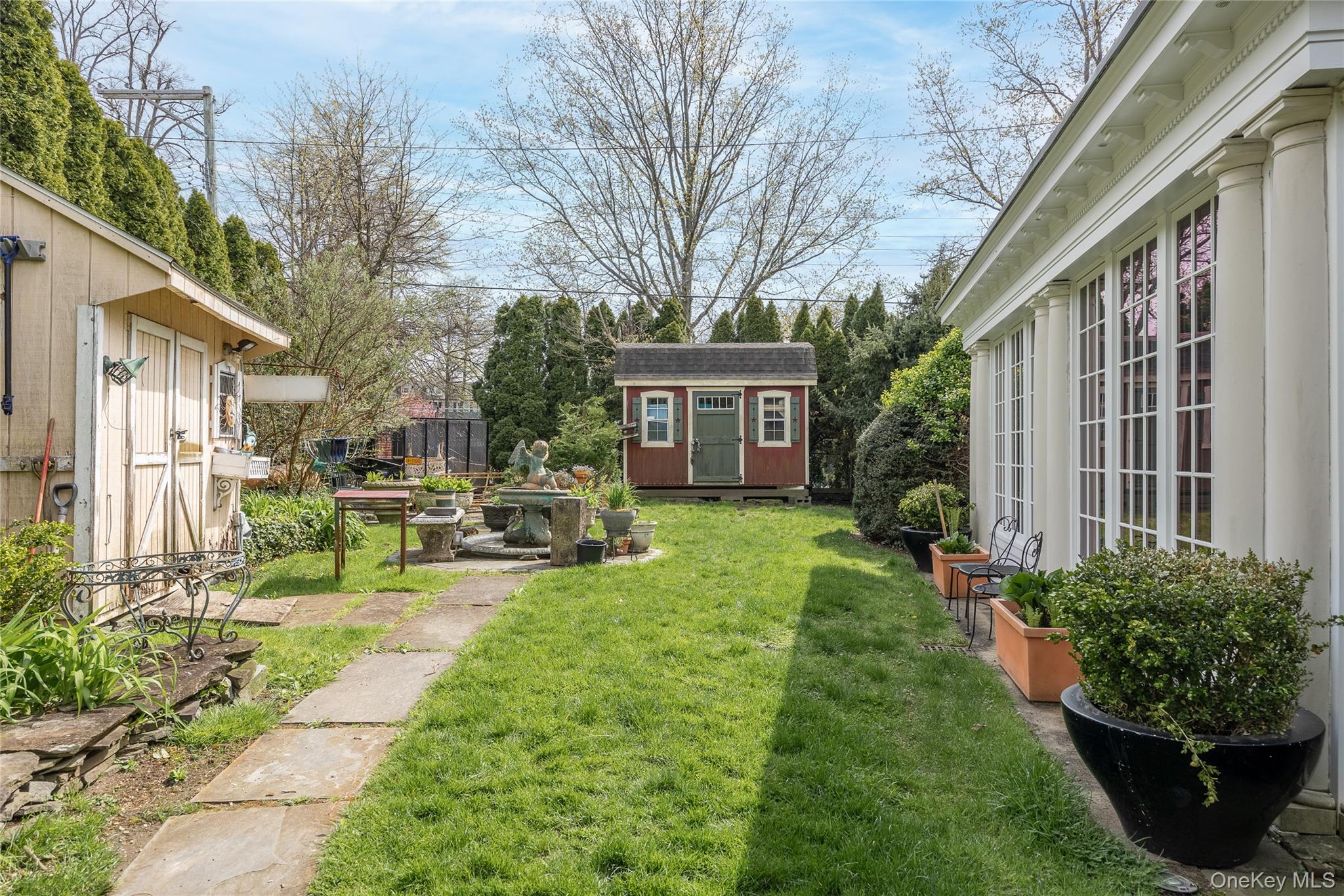 1-27 Beverly Road Queens, NY 11363 - Photo 11 of 46 a view of a house with backyard sitting area and garden