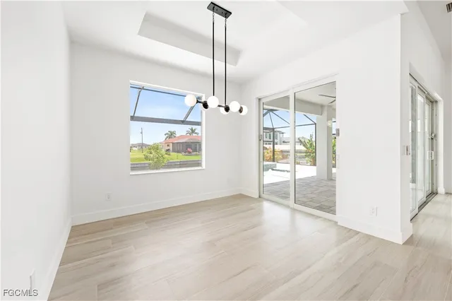 a view of an empty room with window and cabinet