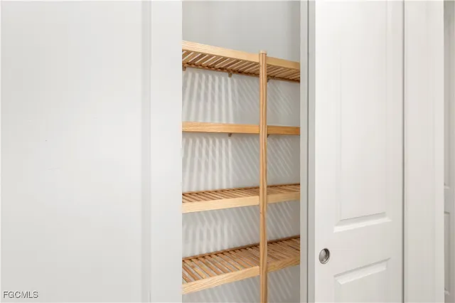 a view of walk in closet with clothes