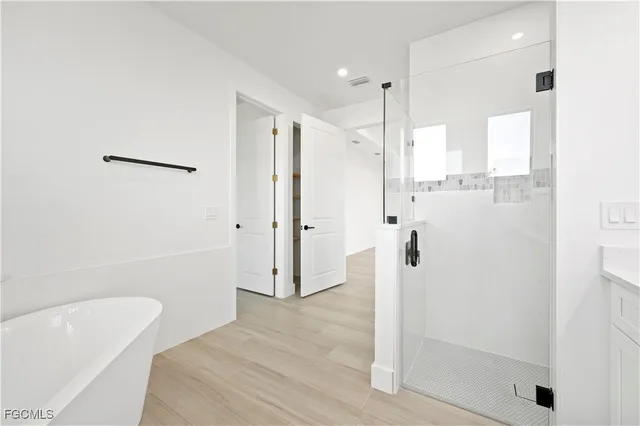 a bathroom with a bathtub and a shower