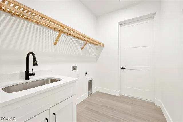 a kitchen with a sink and wooden floor
