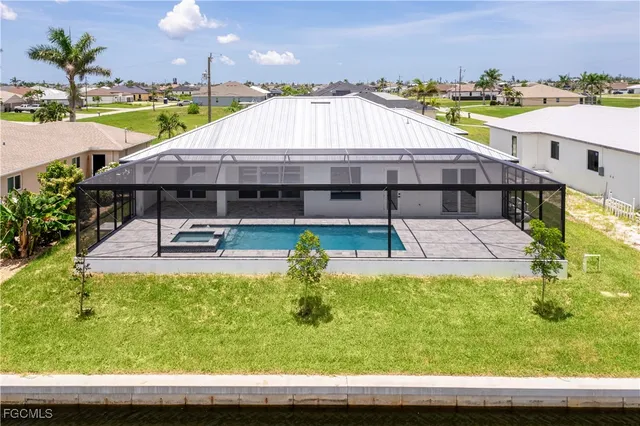 a view of swimming pool with outdoor seating and yard in back