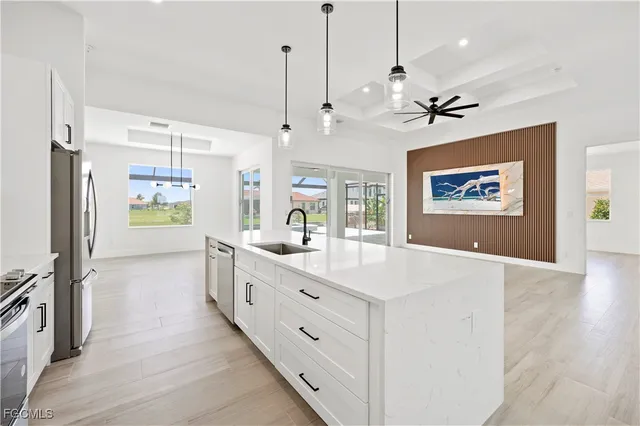 a large white kitchen with a large window
