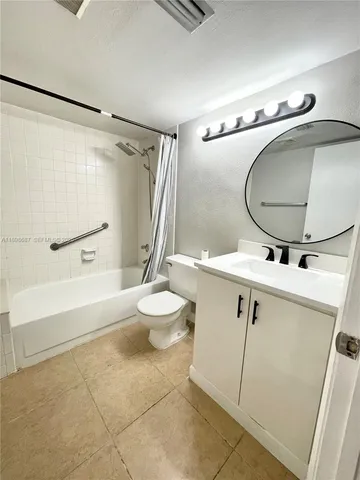 a bathroom with a sink mirror vanity and toilet