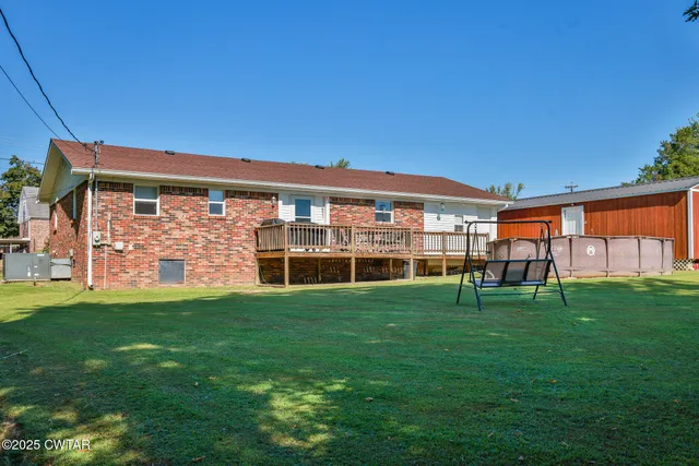 a backyard of a house with table and chairs