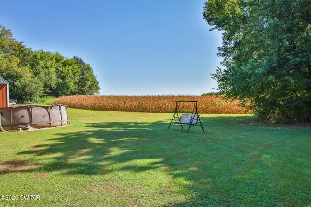 a view of a room with wooden floor and iron stairs
