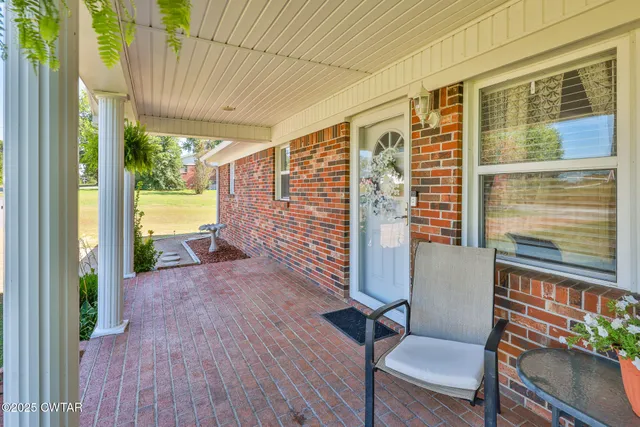 a view of balcony with wooden floor and fence