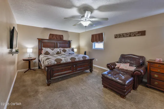 a bedroom with a bed dresser and a window