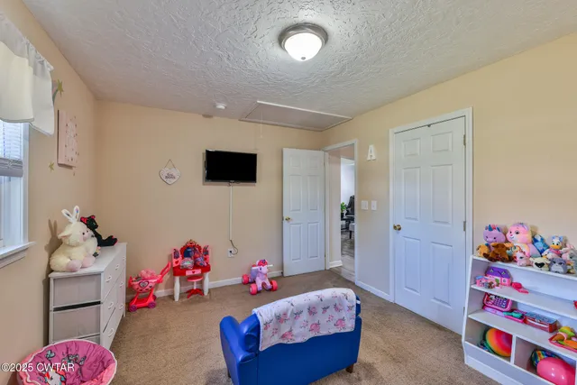 a bedroom with bed and a window