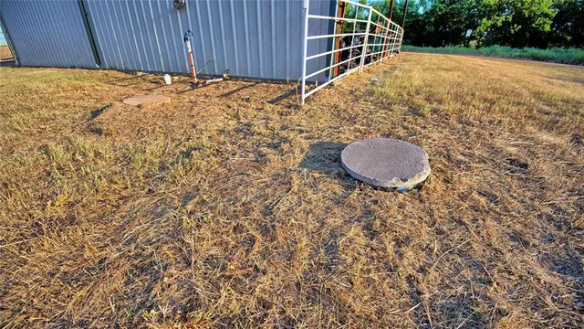 a view of a field with an ocean