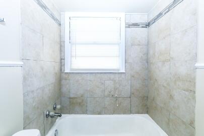 5408 31st Street Lubbock, TX 79407 - Photo 26 of 33 a bathroom with a shower and a toilet