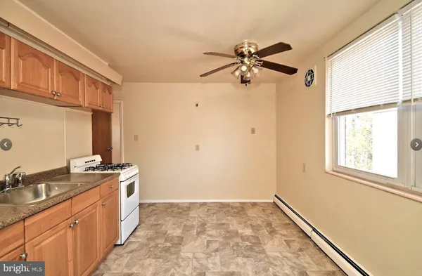a view of a kitchen with a sink and a window
