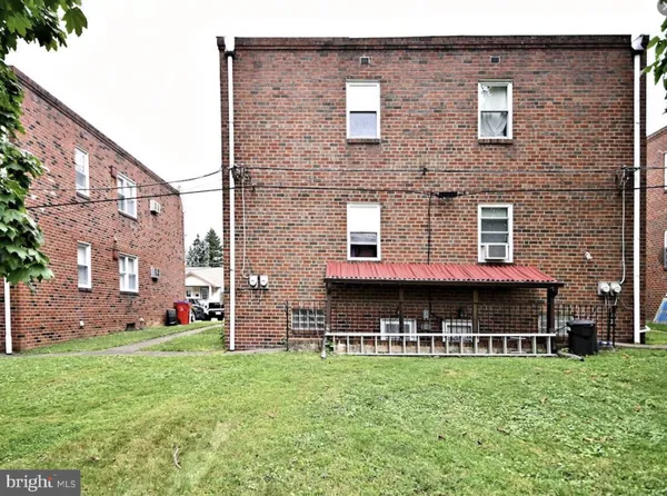 a view of a house with a yard and sitting area