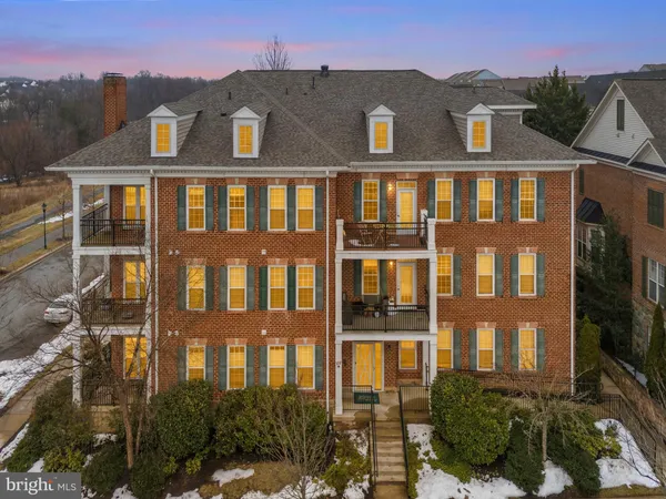 a front view of a residential apartment building with a yard