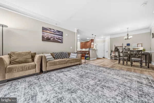 a living room with furniture and a dining table with kitchen view