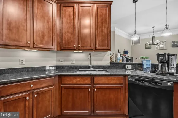 a kitchen with granite countertop wooden cabinets and white appliances