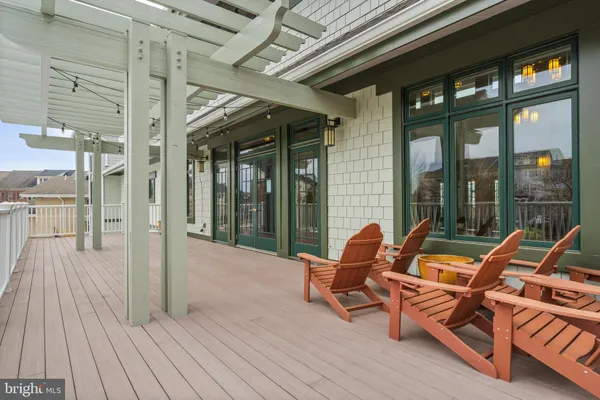 a view of a patio with swimming pool and couches chairs