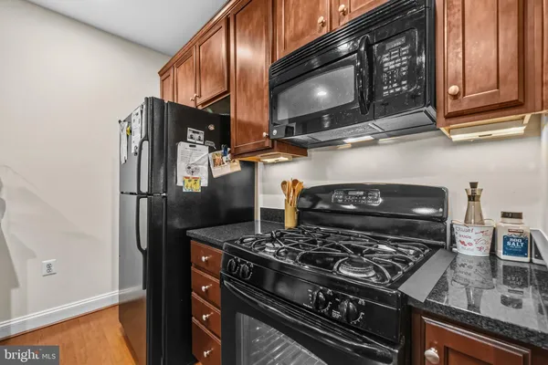 a kitchen with stainless steel appliances granite countertop a stove and a refrigerator