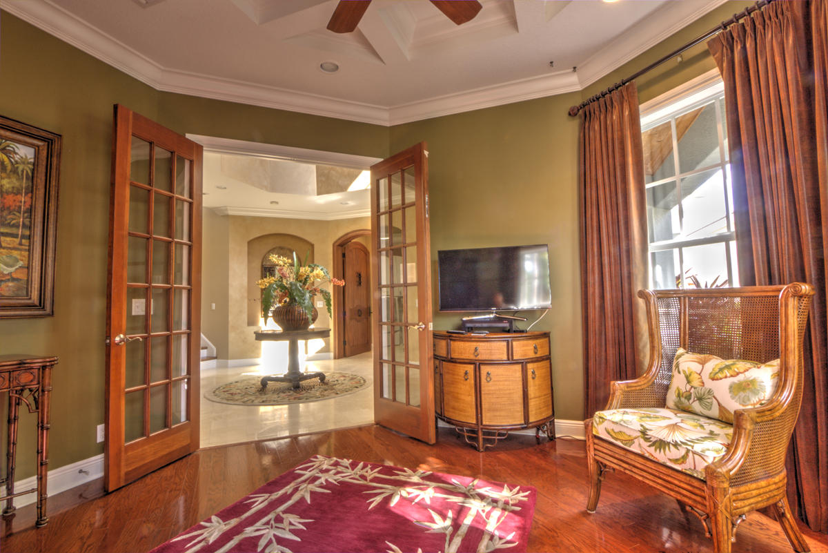 17106 Bay Street Jupiter, FL 33477 - Photo 17 of 52 a living room with patio furniture and a flat screen tv