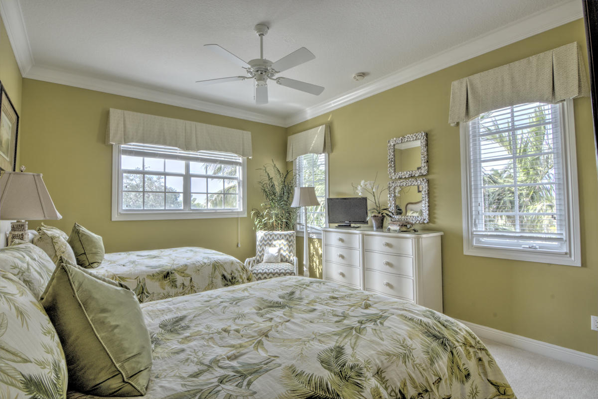 17106 Bay Street Jupiter, FL 33477 - Photo 24 of 52 a bedroom with a large bed and a window