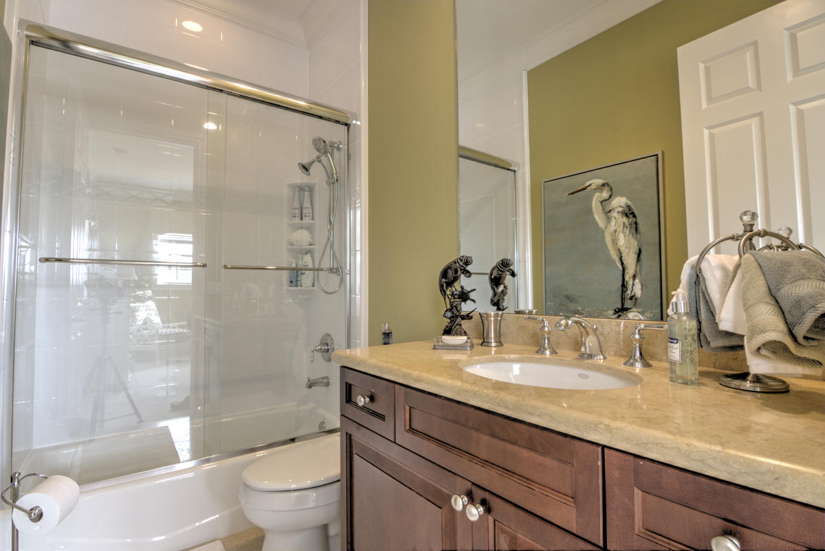 17106 Bay Street Jupiter, FL 33477 - Photo 25 of 52 a bathroom with a granite countertop sink toilet and shower