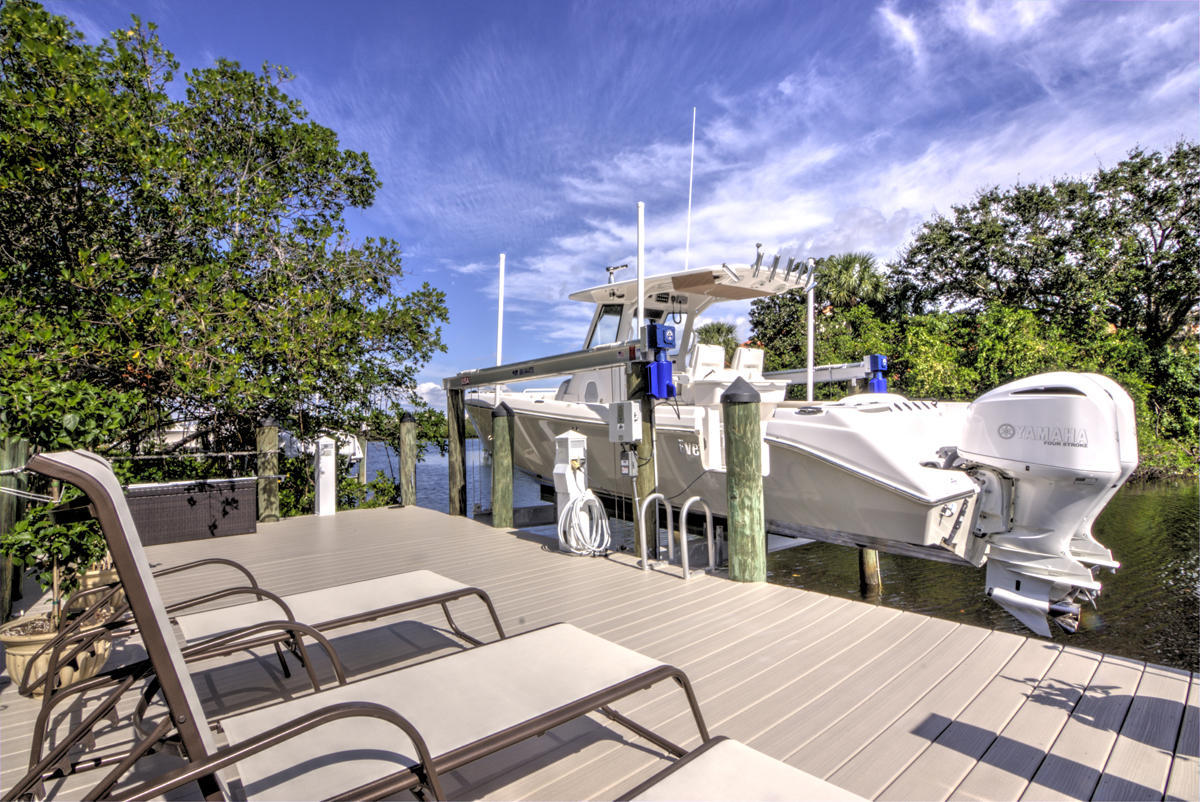 17106 Bay Street Jupiter, FL 33477 - Photo 35 of 52 a view of a patio with a table and chairs