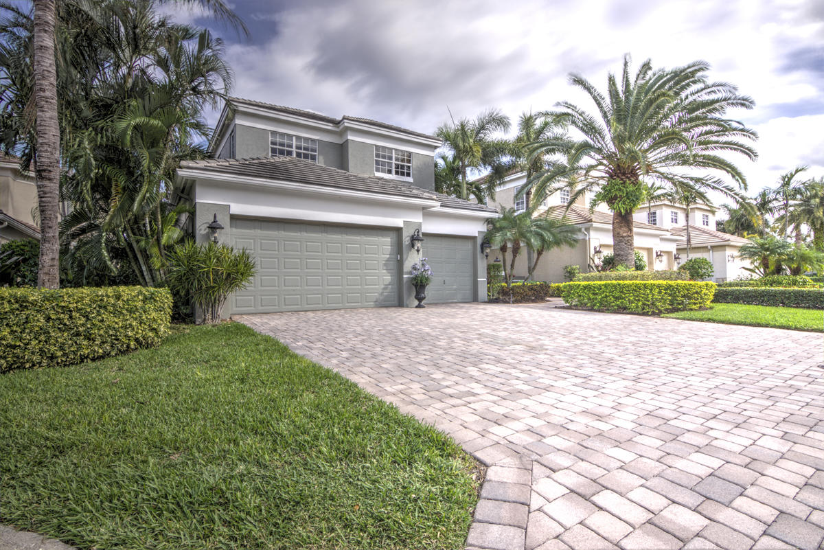 17106 Bay Street Jupiter, FL 33477 - Photo 37 of 52 a front view of a house with garden