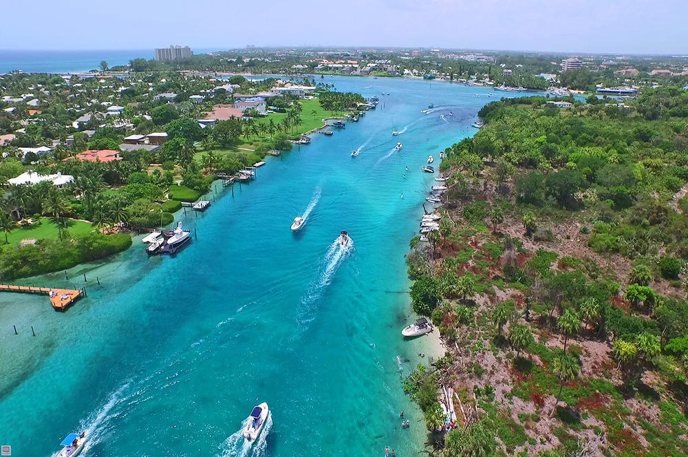 17106 Bay Street Jupiter, FL 33477 - Photo 44 of 52 an aerial view of green landscape with trees houses and mountain view