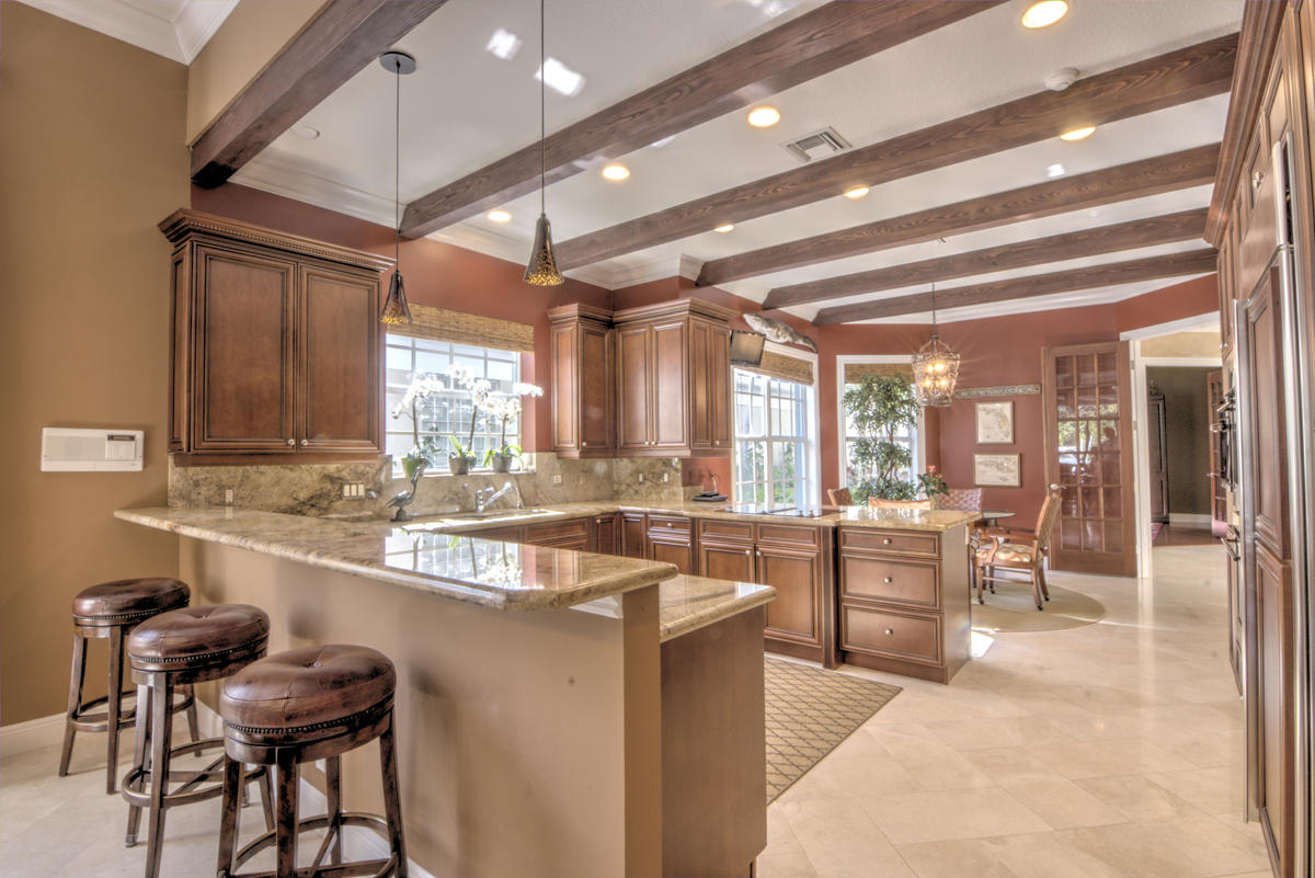 17106 Bay Street Jupiter, FL 33477 - Photo 5 of 52 a room with stainless steel appliances kitchen island granite countertop furniture and a large window