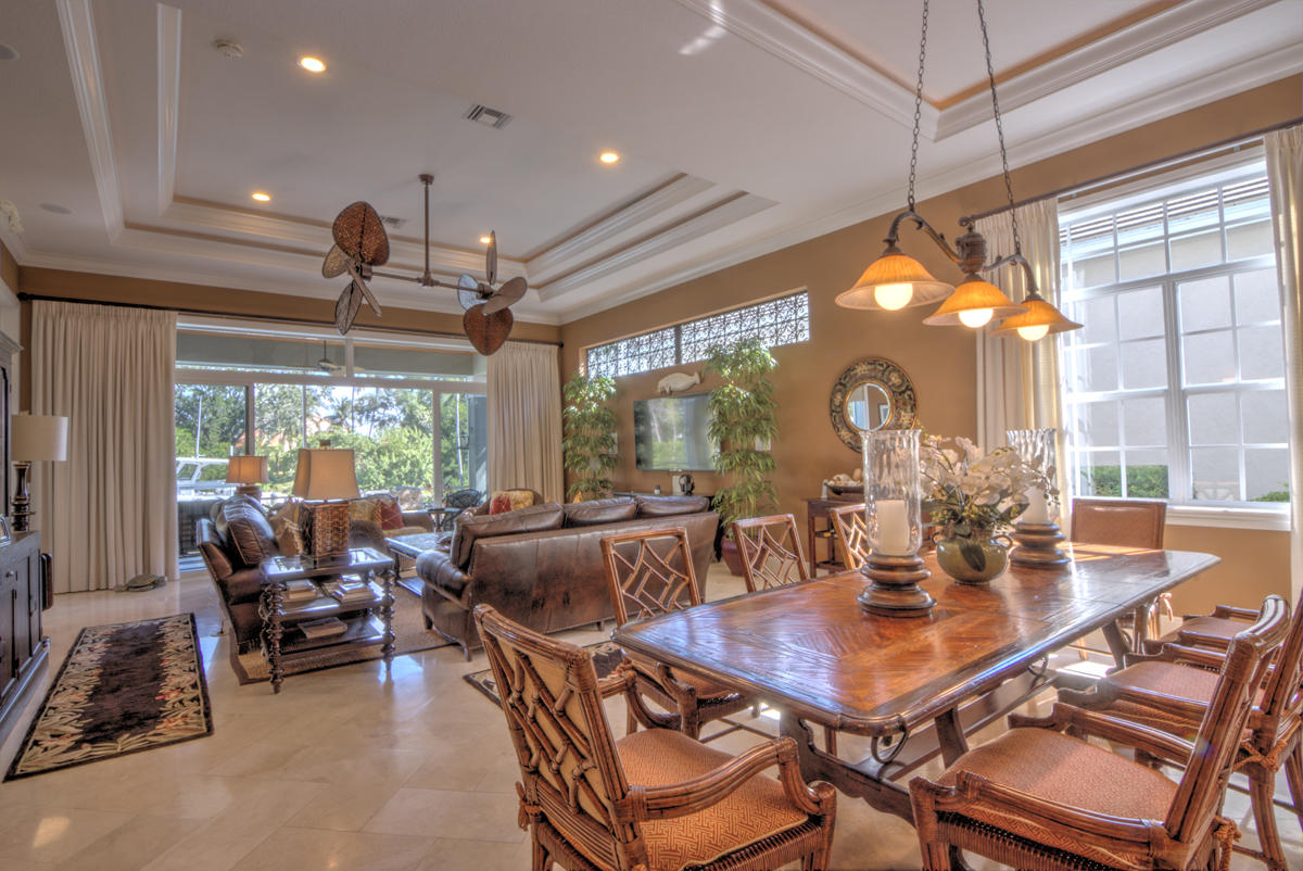 17106 Bay Street Jupiter, FL 33477 - Photo 9 of 52 a view of a dining room with furniture large windows and wooden floor
