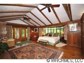 1184 Hunting Country Road Tryon, NC 28782 - Photo 7 of 12 a spacious bedroom with a large bed and a large window