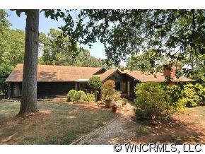 1184 Hunting Country Road Tryon, NC 28782 - Photo 10 of 12 a backyard of a house with table and chairs