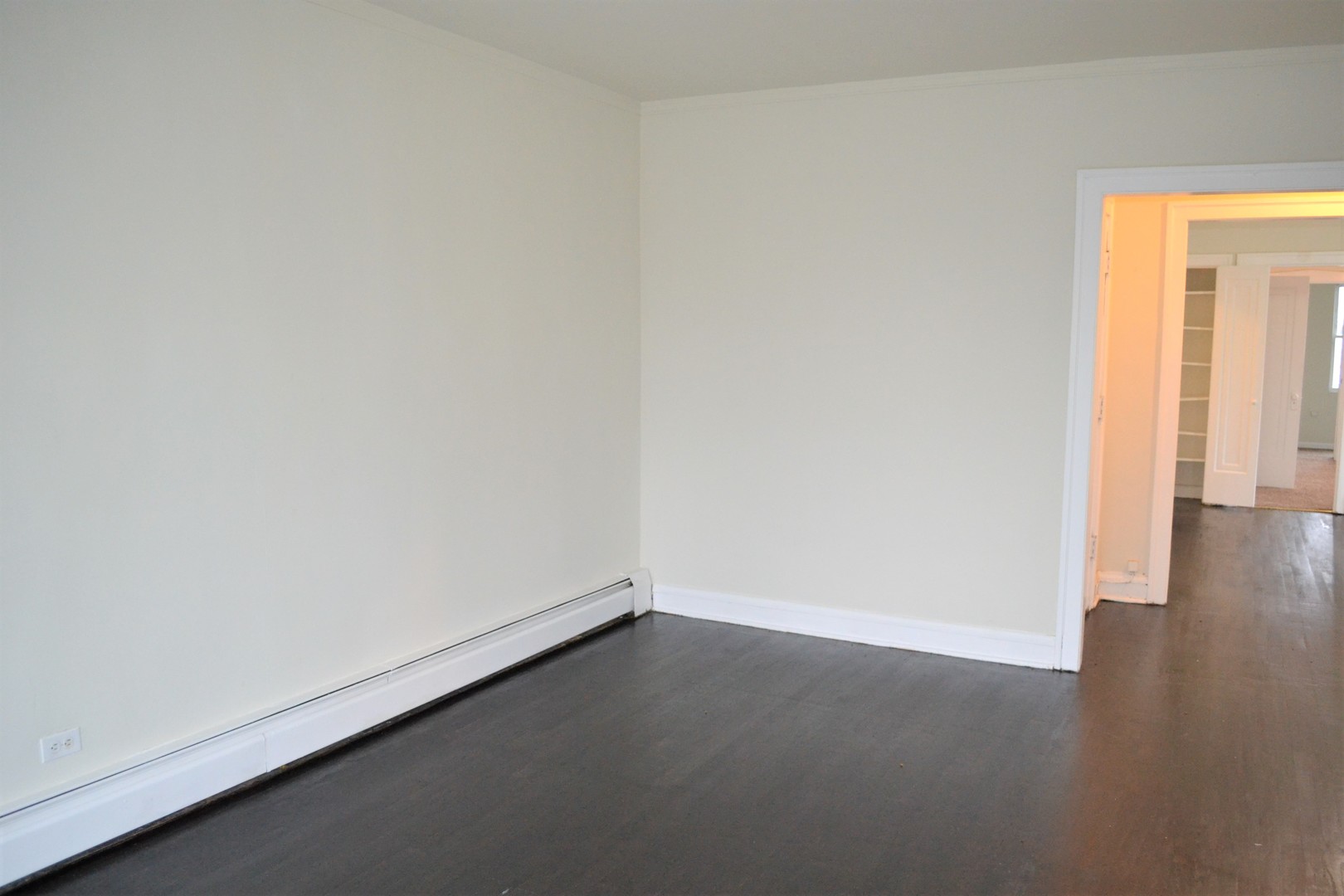 2948 West Nelson Street, Unit 3 Chicago, IL 60618 - Photo 3 of 14 an empty room with wooden floor and windows